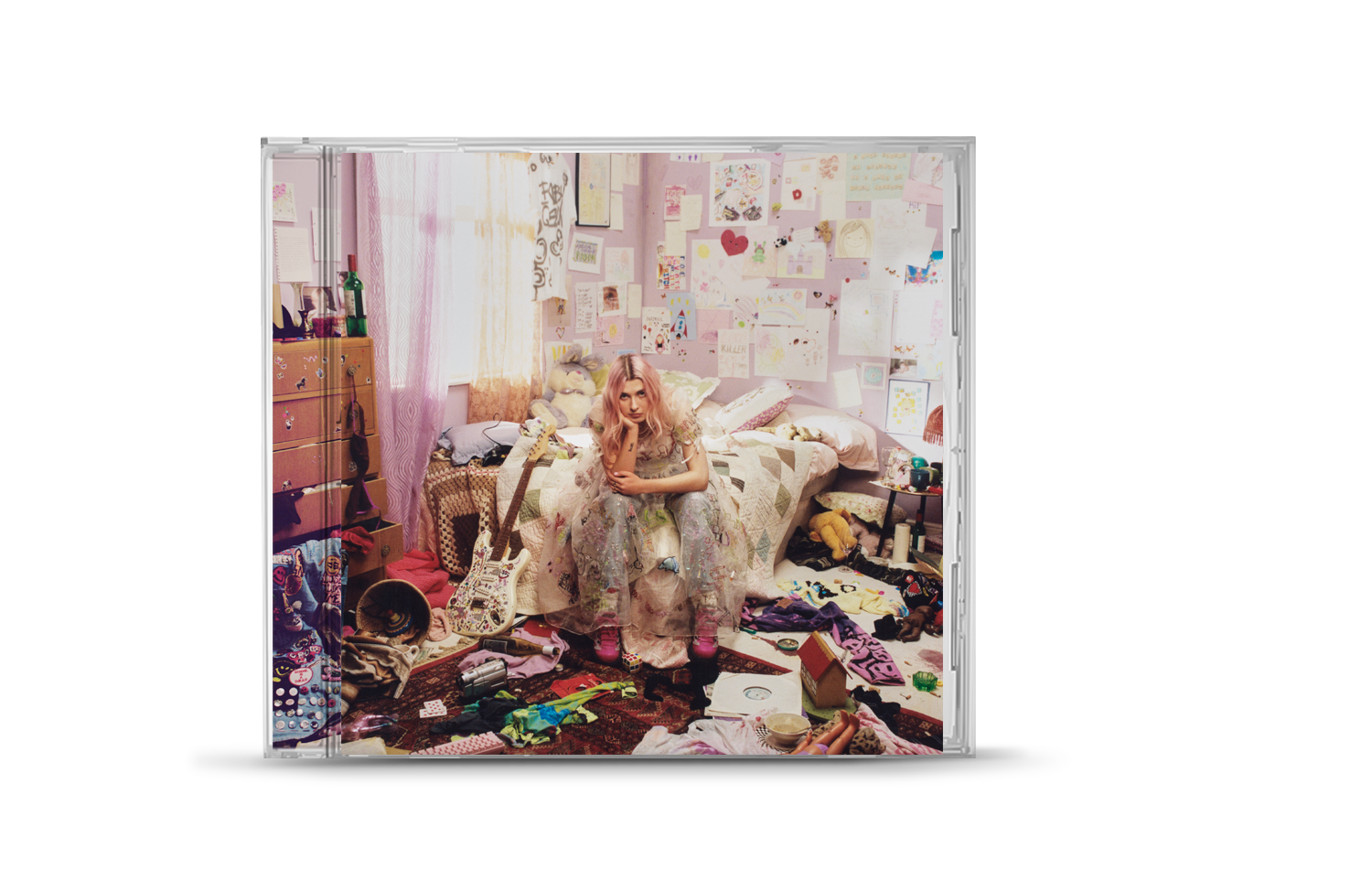 "CD case with a woman sitting in a messy bedroom."