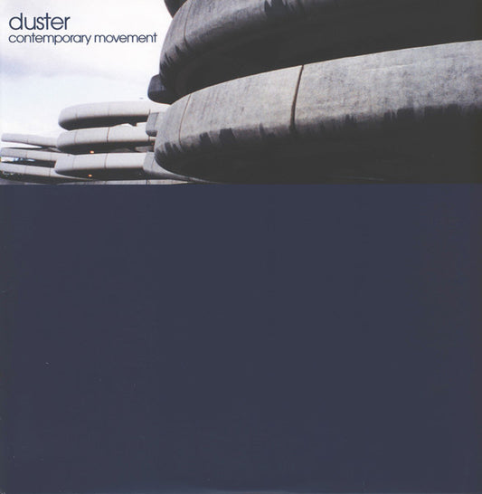 Album cover with abstract grey shapes and dark blue background, featuring "duster" and "contemporary movement" text.