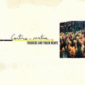 The image is a blurry album cover with a forest scene and text.