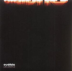 Black vinyl album cover with city skyline silhouette and orange sunset, "audible" and "low lifestyle" text.