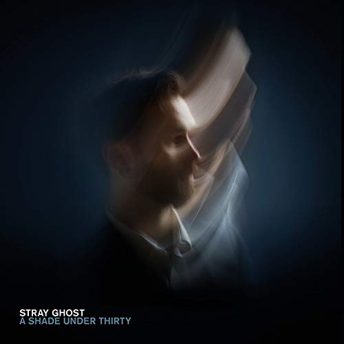Album cover with blurred man in white shirt against dark background.