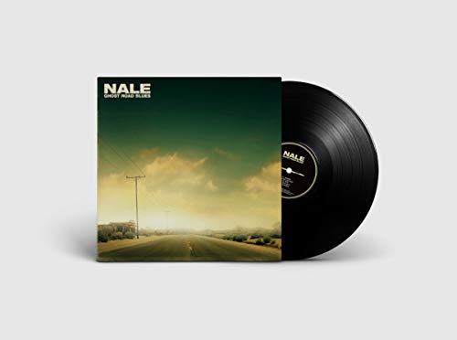 Vinyl record with cover art featuring a road and cloudy sky.