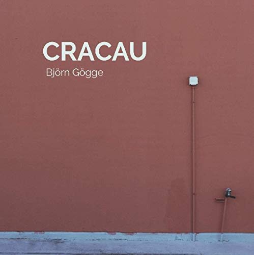 "Red wall with white text 'Cracau' and 'Bjorn Gogge', and a pipe with a tap."