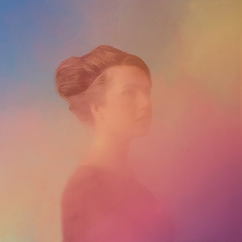 Album cover featuring a woman with brown hair against a multicolored pastel background.