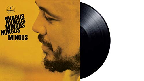 Vinyl record with yellow album cover featuring a man's profile and "Mingus" text.