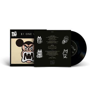 Vinyl record with black sleeve, cartoon face artwork, and partially visible inner sleeve.