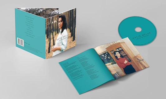 "Katie Melua's 'Love + Money' CD with turquoise packaging, booklet, and disc."