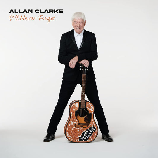 Man in black suit holding a decorated guitar, white background, album cover artwork.