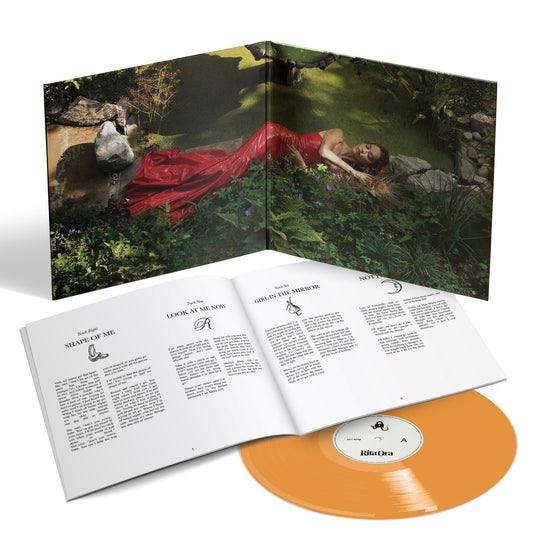 "Orange vinyl record with booklet and cover art featuring a woman in a red dress."