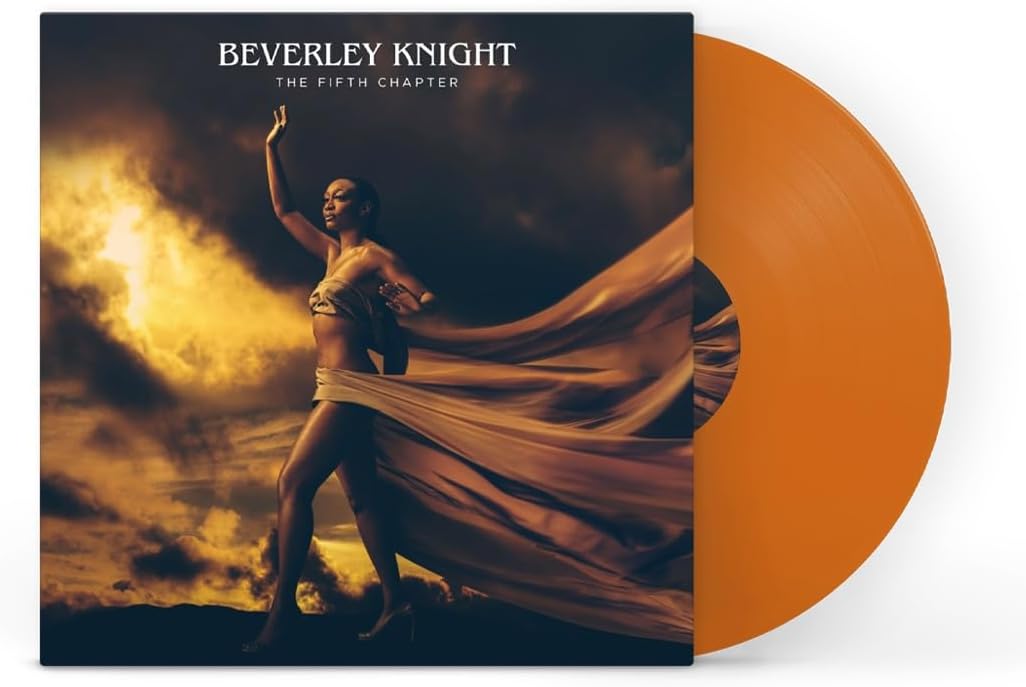 "Orange vinyl record with album cover featuring a woman in flowing dress."