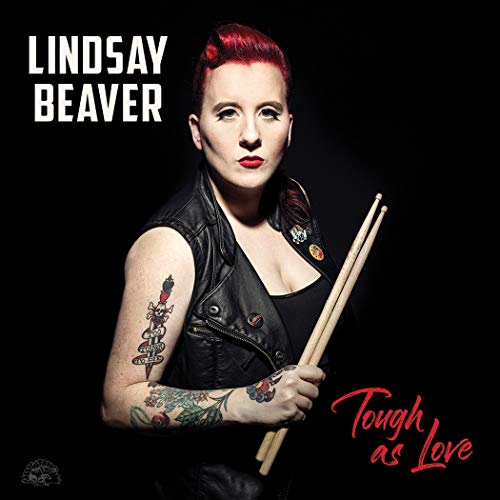 Album cover featuring a woman with red hair holding drumsticks against a black background.