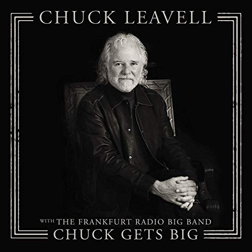 Black and white vinyl album cover with a seated man in a leather jacket.