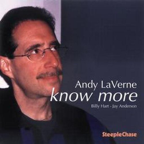 "CD cover featuring a man with glasses and mustache, against a dark background."