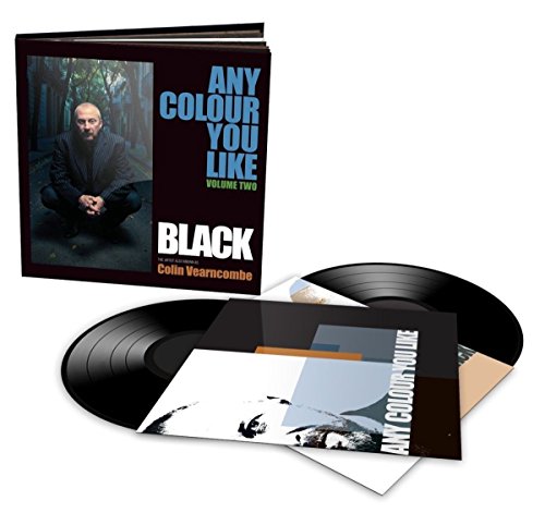 "Vinyl record set with hardback book and album cover featuring a man in dark clothing."