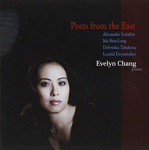 "CD cover featuring a woman with dark hair, black top, against a dark background."