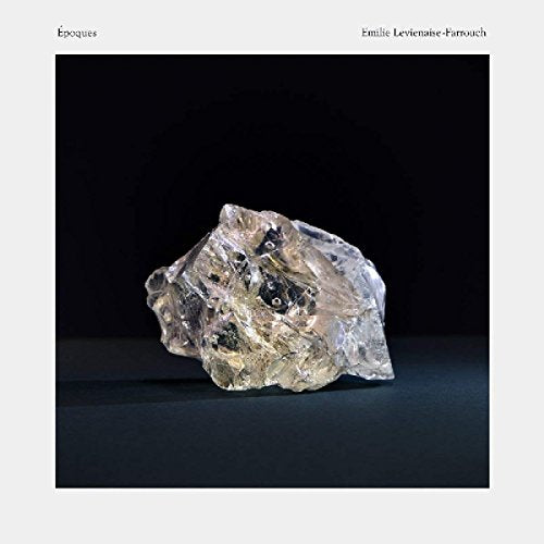 Album cover featuring a large, irregularly shaped crystal against a dark background, with white border.