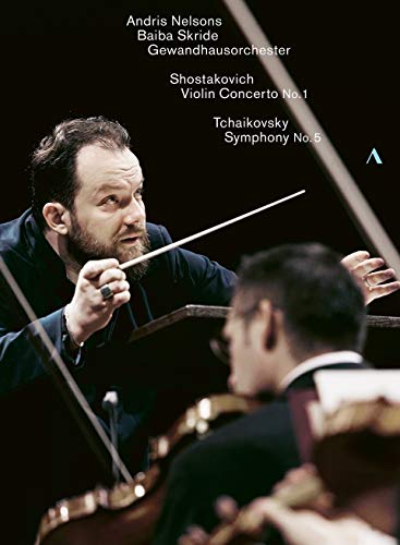Conductor Andris Nelsons leads an orchestra, baton in hand, against a dark background.