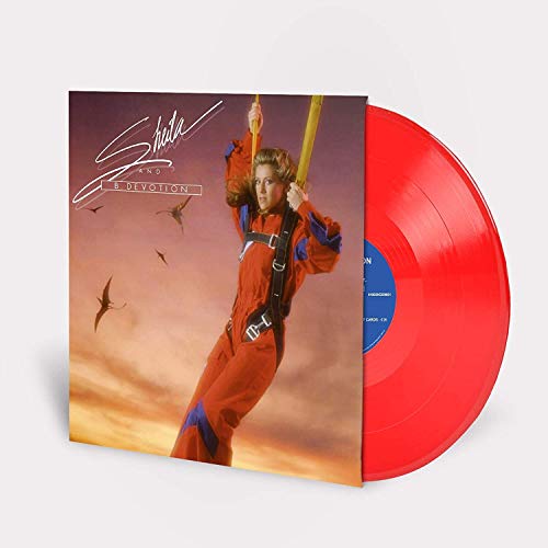 "Album cover featuring a person in a red jumpsuit holding a parachute handle."