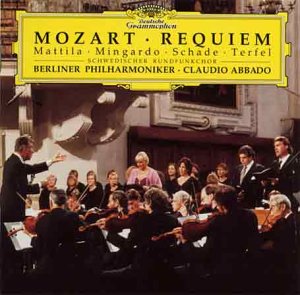 A CD cover featuring a conductor and musicians in a concert hall, with yellow title banner.