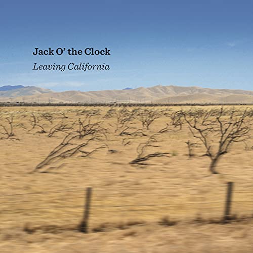 "CD album cover with desert landscape, bare trees, and mountains under a blue sky."