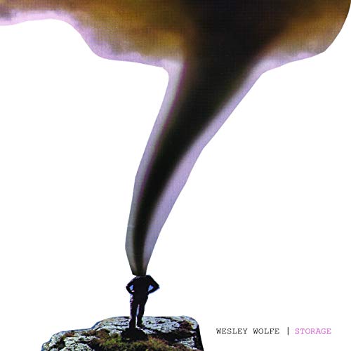 CD album cover featuring a person standing on a rock with a dark, swirling mist.