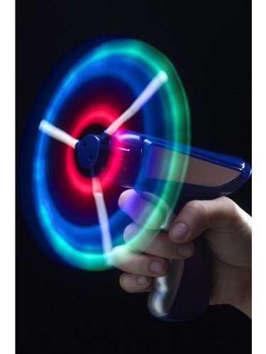 A hand holds a blue toy windmill gun with spinning, glowing blue and green blades.