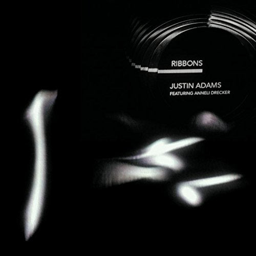 "Black album cover with white text 'Ribbons' and 'Justin Adams' and a CD reflection."