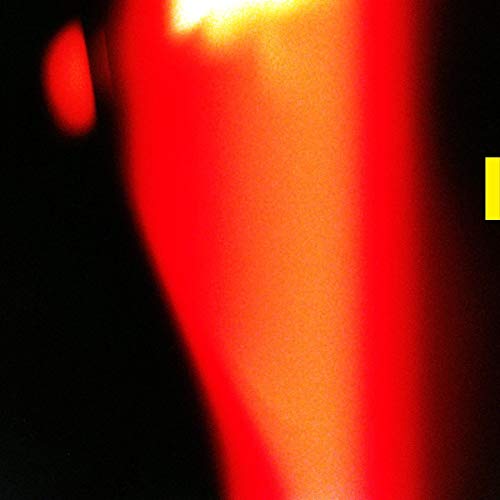 The image depicts a vinyl record with a red and orange cover. Alt text: Red and orange vinyl record cover with yellow text.