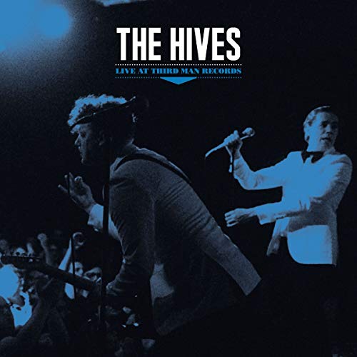 "Album cover featuring two musicians performing on stage, blue-toned and dark background."
