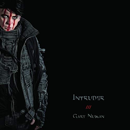 "Gary Numan album cover with man in dark attire and red face paint."