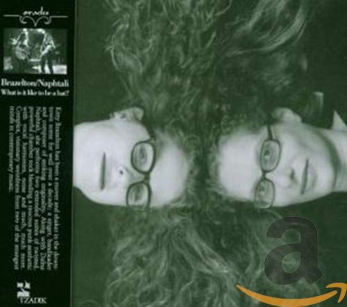 A black-and-white album cover featuring a mirrored image of a person's face.