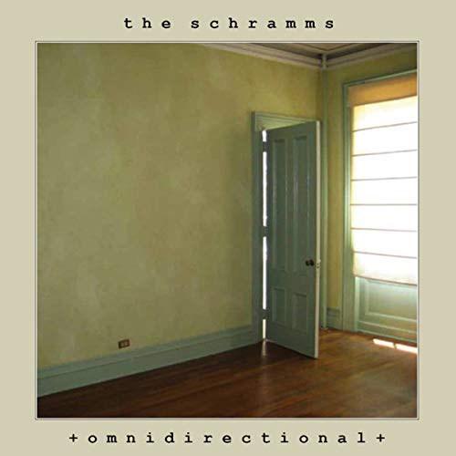 The image depicts a vinyl record cover featuring a pale, empty room. #### Alt text: "Album cover with pale room, open door, and window, on beige background."