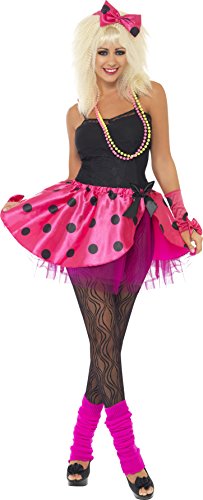 A woman in a black top, pink tutu, and blonde wig stands against a white background.