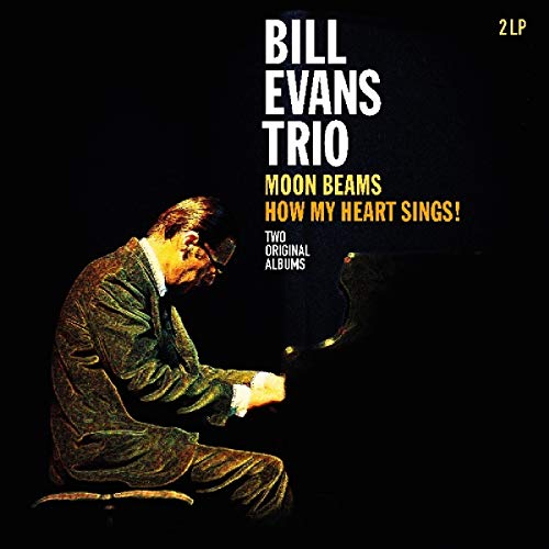Bill Evans playing piano on vinyl album cover with black background and white text.