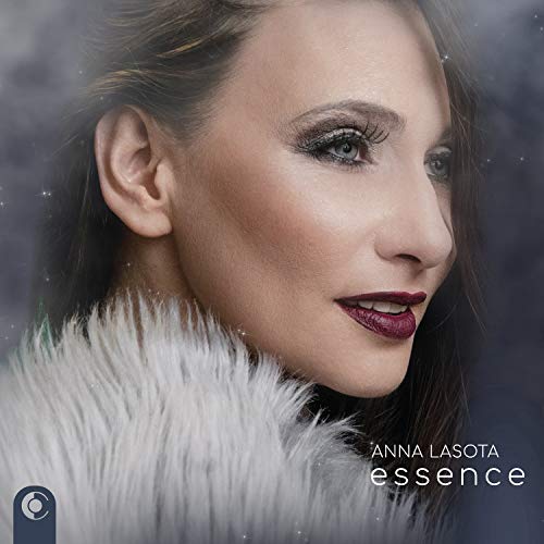 "Album cover featuring a woman in a white fur coat with 'Anna Lasota essence' text."