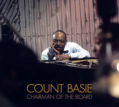 "Album cover featuring Count Basie sitting at a piano with text 'Count Basie'."