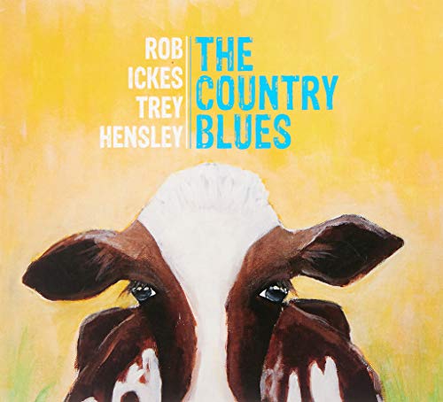 Album cover with a cow's face on a yellow background, featuring artist names and title.