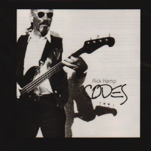 "Album cover with black and white photo of man playing a bass guitar."