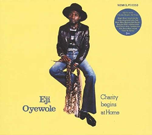 Album cover featuring a man sitting on a saxophone against a yellow background.