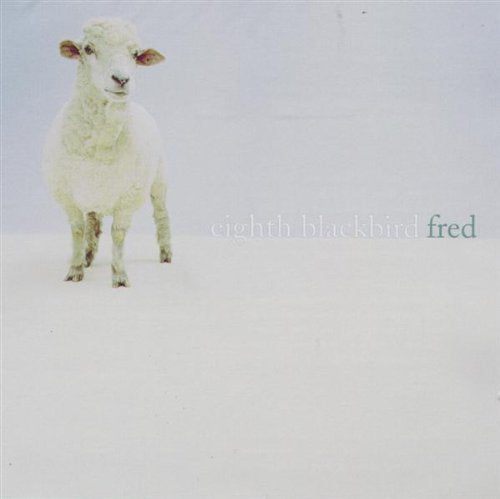 A white sheep stands on snow with the text "eighth blackbird fred" beside it.