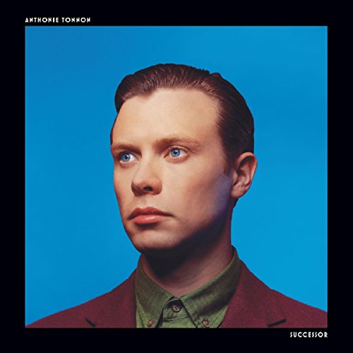"Album cover featuring a man with blue eyes against a blue background."