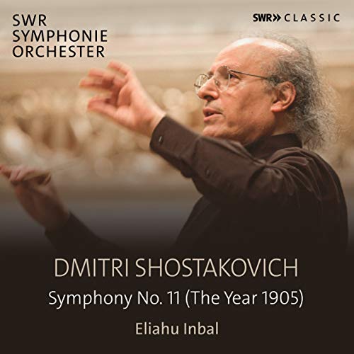 "CD cover featuring a conductor with outstretched arms, blurred background, and white text."