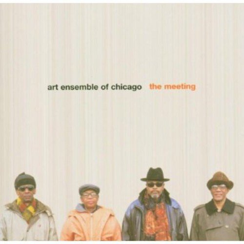 "CD cover with four men in hats and coats, beige curtain background."