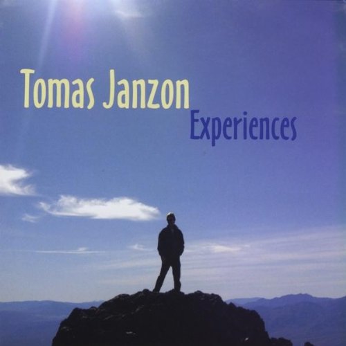 "Album cover featuring a man standing on a rocky outcrop against a blue sky."