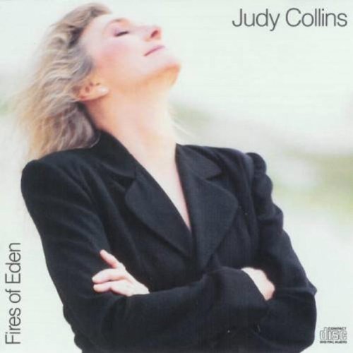 "CD cover with Judy Collins in a black jacket, arms crossed, against a white background."