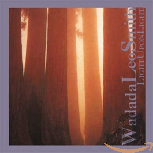 "Album cover with tall trees and sunlight, artist and title text on right side."