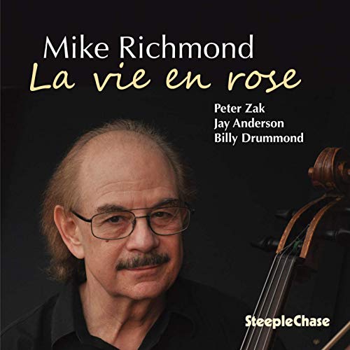 CD cover featuring a man with glasses and a mustache against a black background.