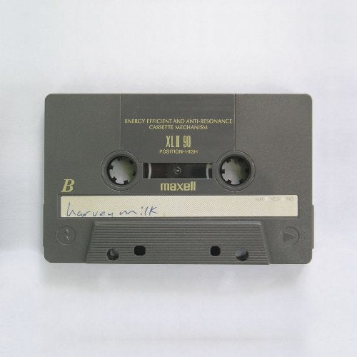 A Maxell XLII 90 cassette tape labeled "harvey milk" on a white background.