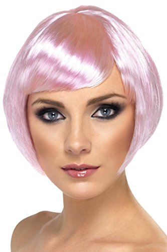 A woman wearing a short, shiny pink wig with straight bangs on a white background.