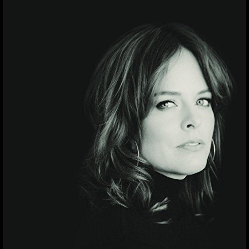 Black and white close-up portrait of a woman with shoulder-length wavy hair.